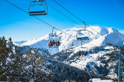 People riding up on a ski chair lift in andorra