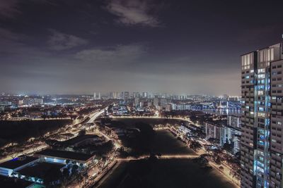 High angle view of city lit up at night