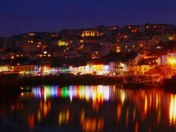 Reflection of illuminated cityscape in water