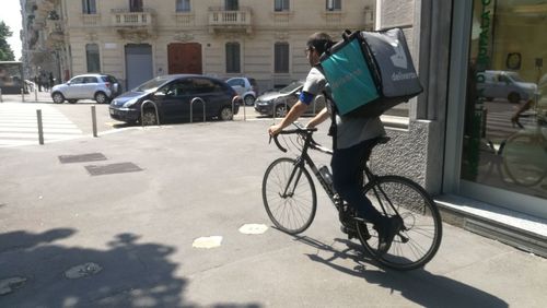 Man riding bicycle on street in city