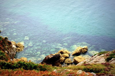 High angle view of rocks in sea