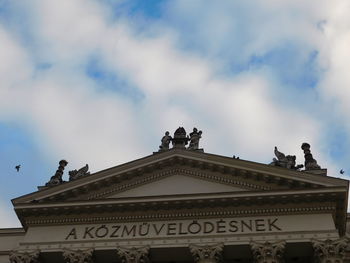 Low angle view of building against cloudy sky