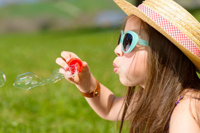 Close-up portrait of girl with bubbles in water