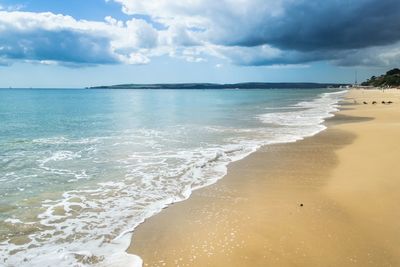 Scenic view of sea against cloudy sky