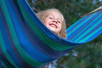 Smiling girl playing on hammock