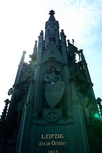 Low angle view of statue of historic building against sky