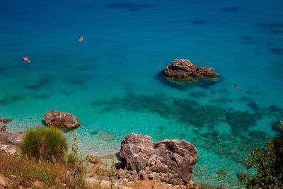 High angle view of rocks on sea shore