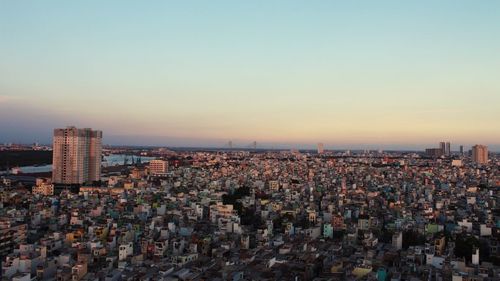 View of cityscape against clear sky during sunset