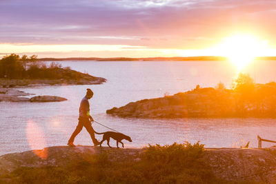 Man with dog by lake