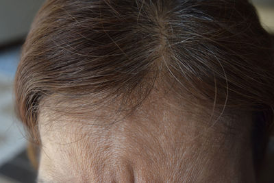 Close-up of woman showing forehead