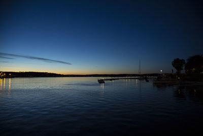 Scenic view of sea against clear sky at night