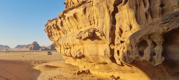 Rock formations on mountain against clear sky