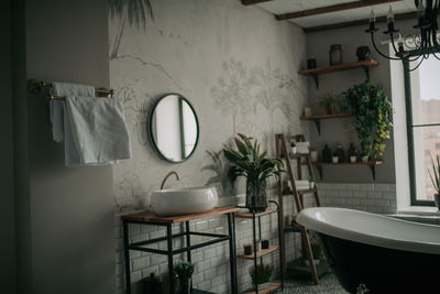 Luxury interior of big bathroom at modern african style with oval bathtub in natural lighting