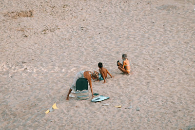 High angle view of people sitting on beach