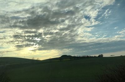 Scenic view of field against sky during sunset