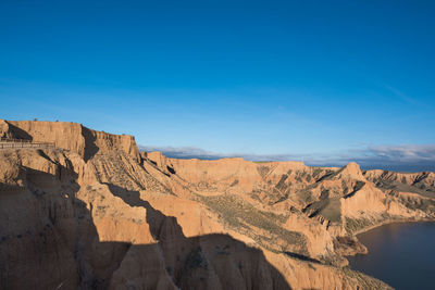 Scenic view of mountain against blue sky