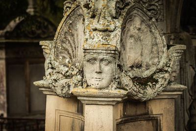 Close-up of statue against old building