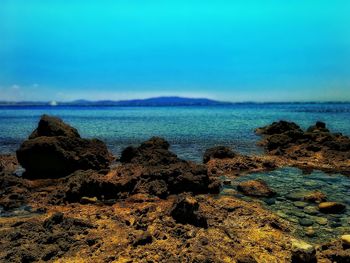 Scenic view of sea against blue sky