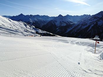 Scenic view of snow covered mountains against sky