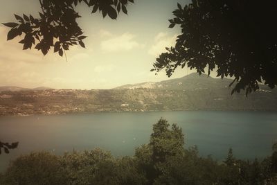 Scenic view of lake against cloudy sky