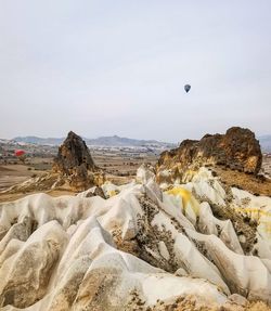 Scenic view of rocks on landscape against sky