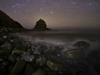 Scenic view of sea against sky at night