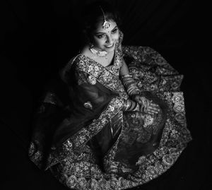 High angle view of smiling bride wearing traditional clothing looking up