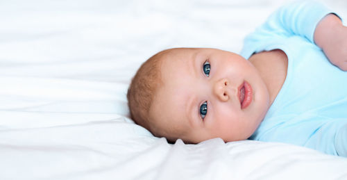 Portrait of a beautiful baby on white. head and face. newborn lying on its side. adorable infant 