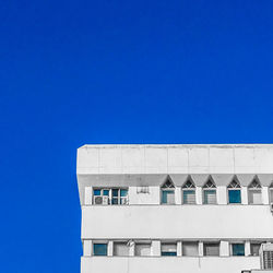 Low angle view of building against clear blue sky