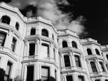 Low angle view of building against cloudy sky