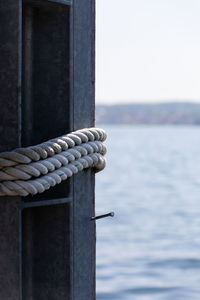 Close-up of rope tied on wooden post
