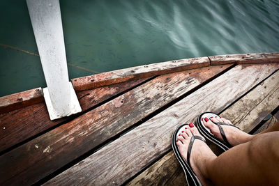 Low section of woman standing on boat