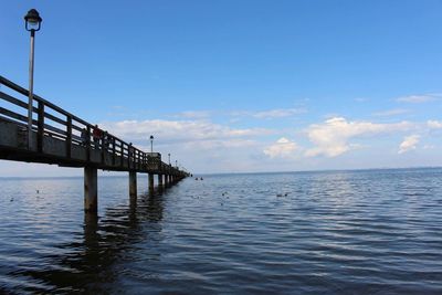 Pier over sea against sky