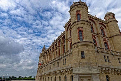 Low angle view of clock tower against sky