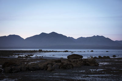 Scenic view of sea and mountains against sky