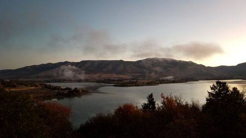 Scenic view of lake and mountains against sky