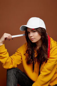 Portrait of beautiful young woman holding camera