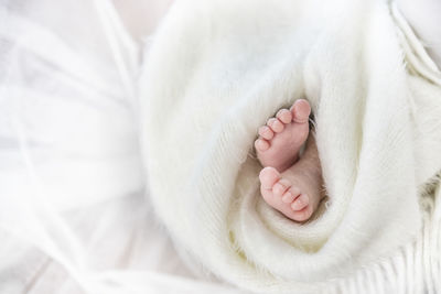 Close-up of baby feet on bed