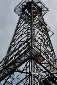 Low angle view of crane against sky