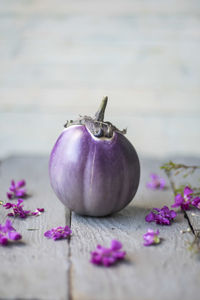 Close-up of eggplant amidst flowers on table