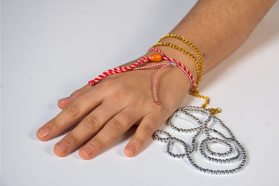 Low section of woman wearing ring against white background