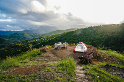 Scenic view of road by mountains against sky