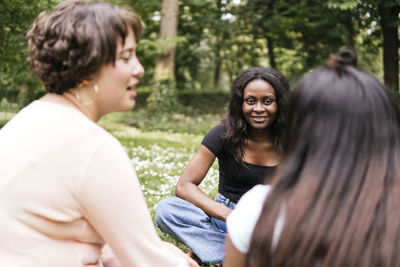 Happy women talking in park