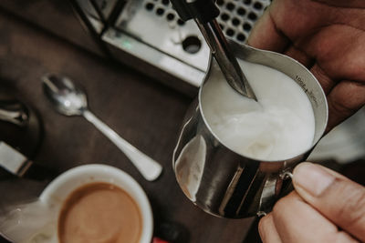 Cropped image of hand holding coffee cup