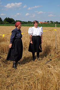 Full length of friends on field