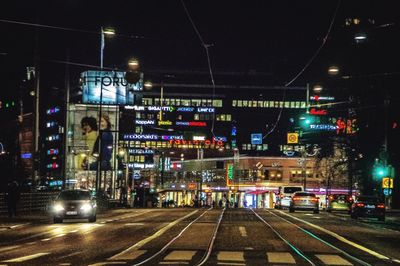 Railroad tracks in city at night