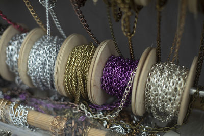 Chain decoration on coils. sale of jewelry. chains wound on reels. different threads for creativity.