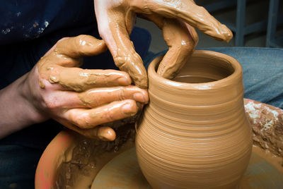Cropped image of potter making clay pot