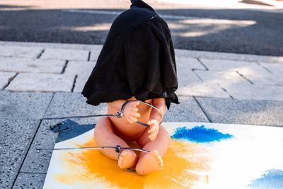 Low section of woman standing on street