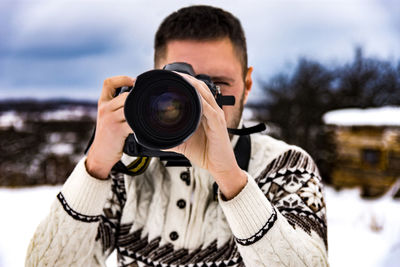 Portrait of man photographing with snow